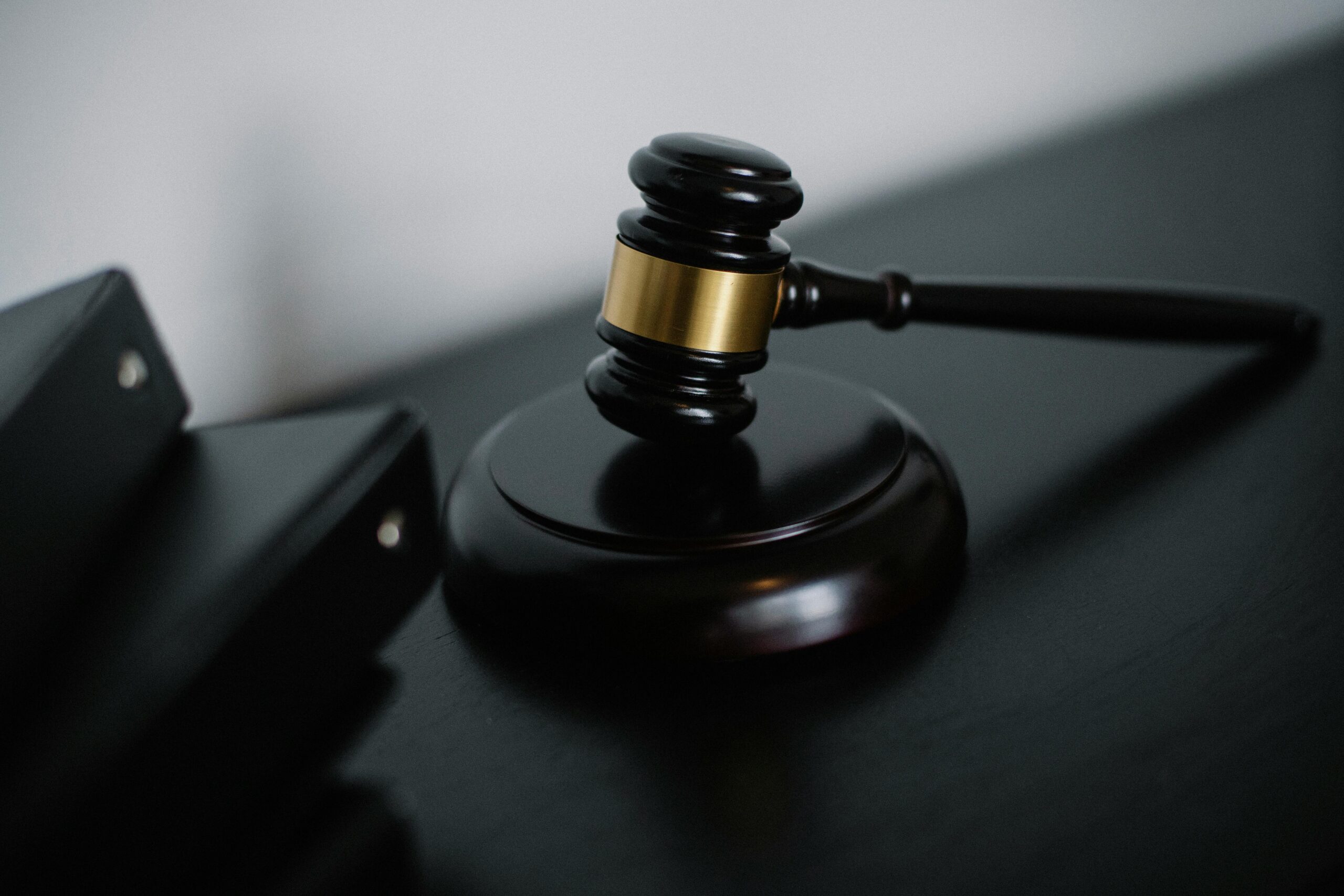 Close-up of a gavel resting on a sound block, symbolizing an auction or legal decision.